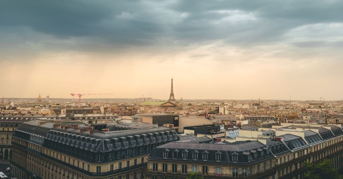 Paris skyline with the Eiffel Tower beneath stormy clouds, reflecting the unpredictable drama of Paris weather.
