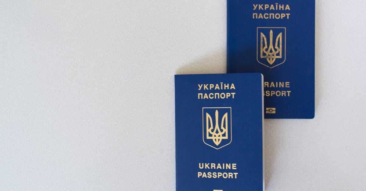 Two passports on a white surface, key travel documents to tick off your travel checklist.