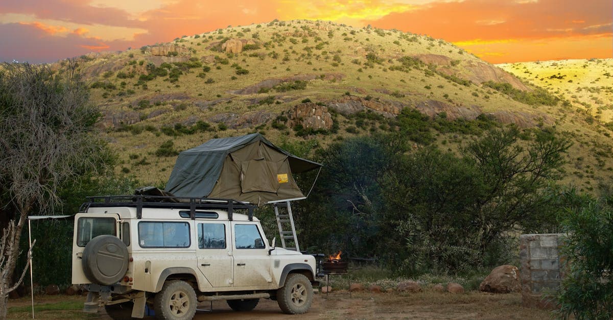 Land Rover with rooftop tent at sunset in the Karoo, where safari travel insurance covers remote evacuations