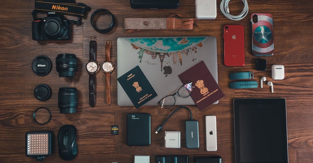 Flat lay of winter travel essentials including gadgets, passport, and camera for North India trips.