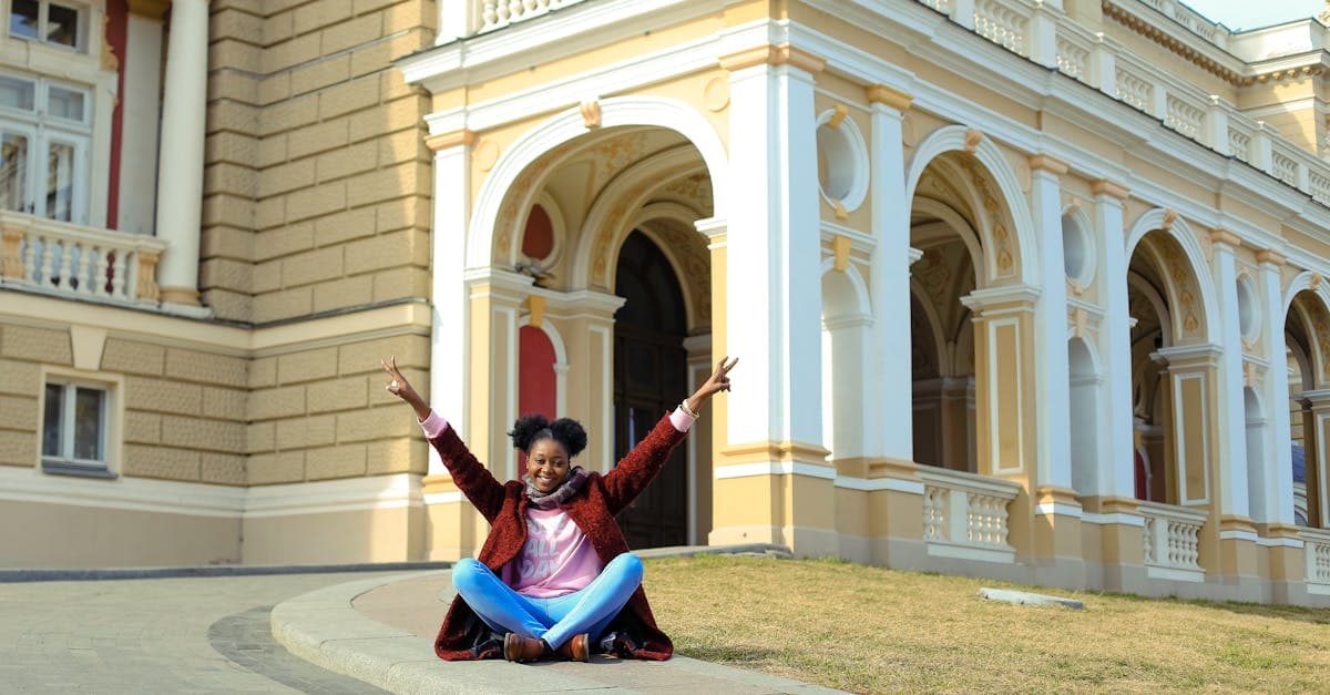South African woman smiling outside a European landmark after setting up a travel eSIM for her solo trip