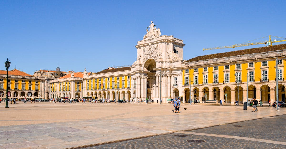 Lisbon's iconic Praça do Comércio and historic Rua Augusta arch under vibrant Portuguese skies.