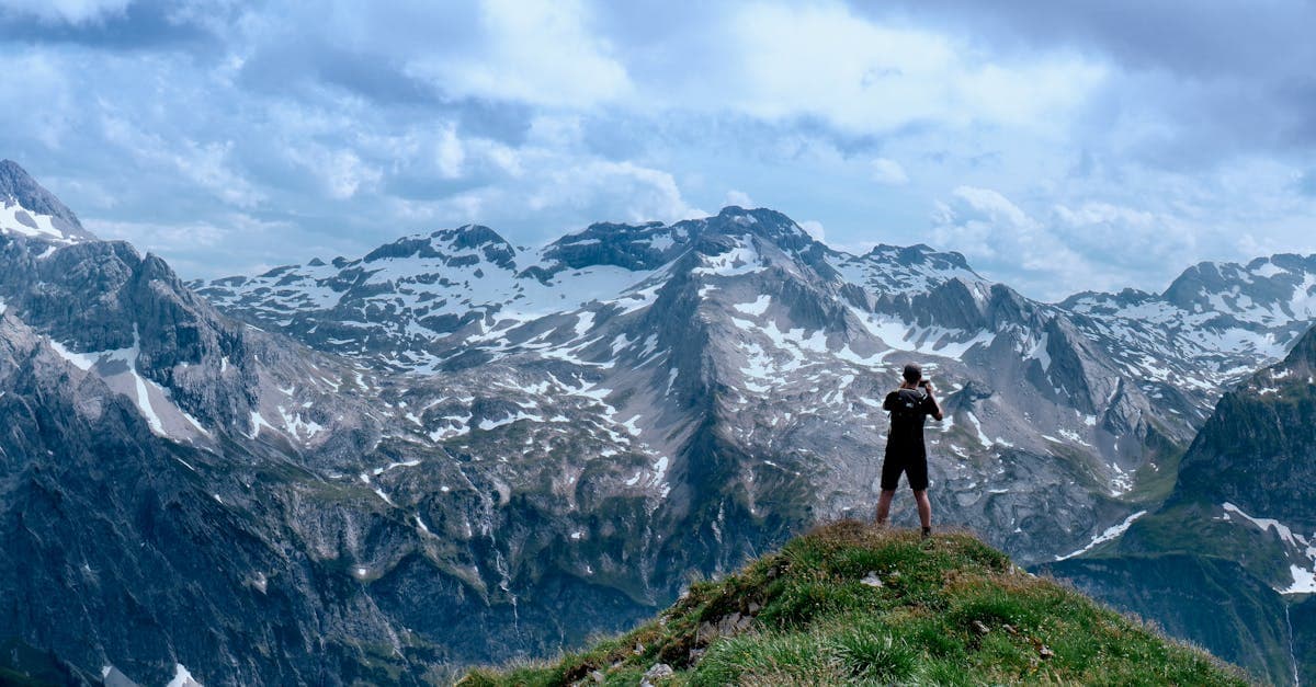 Lone hiker capturing breathtaking snowy peaks along the Rishikesh and McLeod Ganj mountain trails