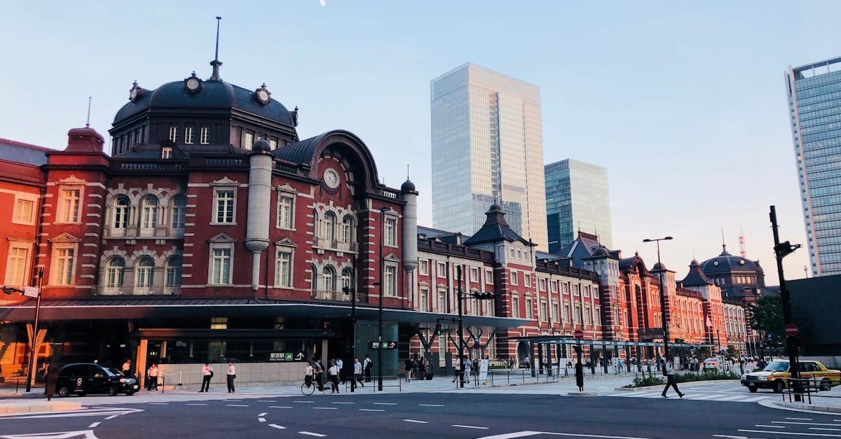 Tokyo Station's iconic redbrick facade glowing at dusk, a central rail hub for journeys across Japan