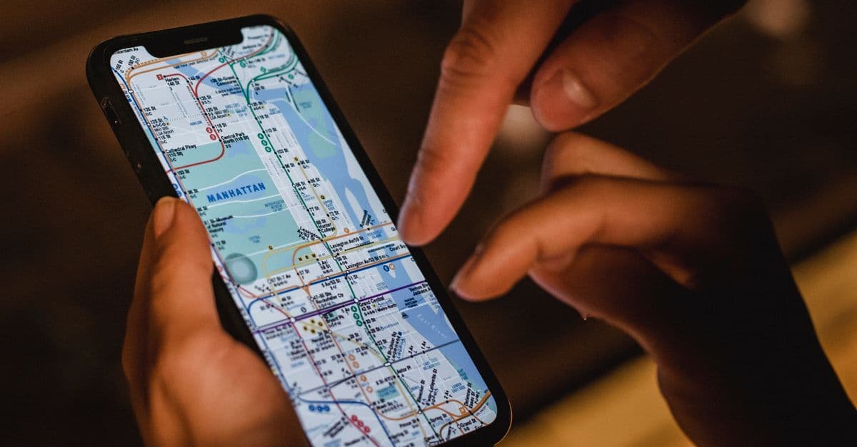 Couple using a smartphone to navigate city streets while traveling in the US