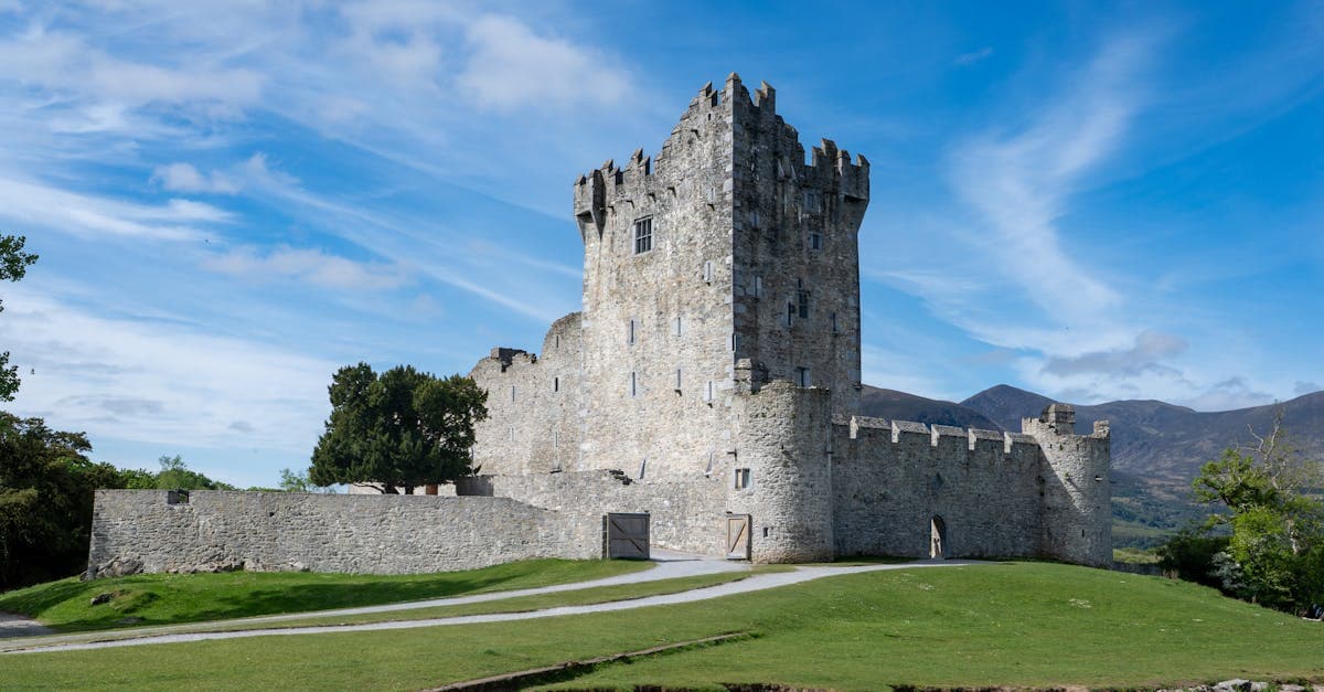 Ross Castle in Killarney reflected under blue skies, a top destination for the best time to visit Ireland