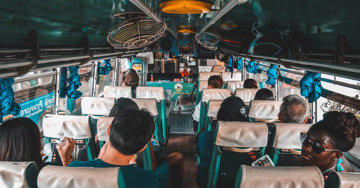 Group of tourists on a bus through Kanchanaburi, Thailand, discussing esim thailand connectivity options