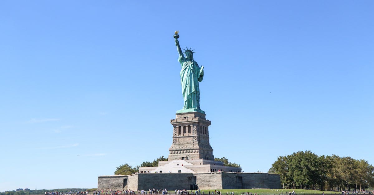 Iconic Statue of Liberty on sunny day in New York City, symbol of freedom and democracy.