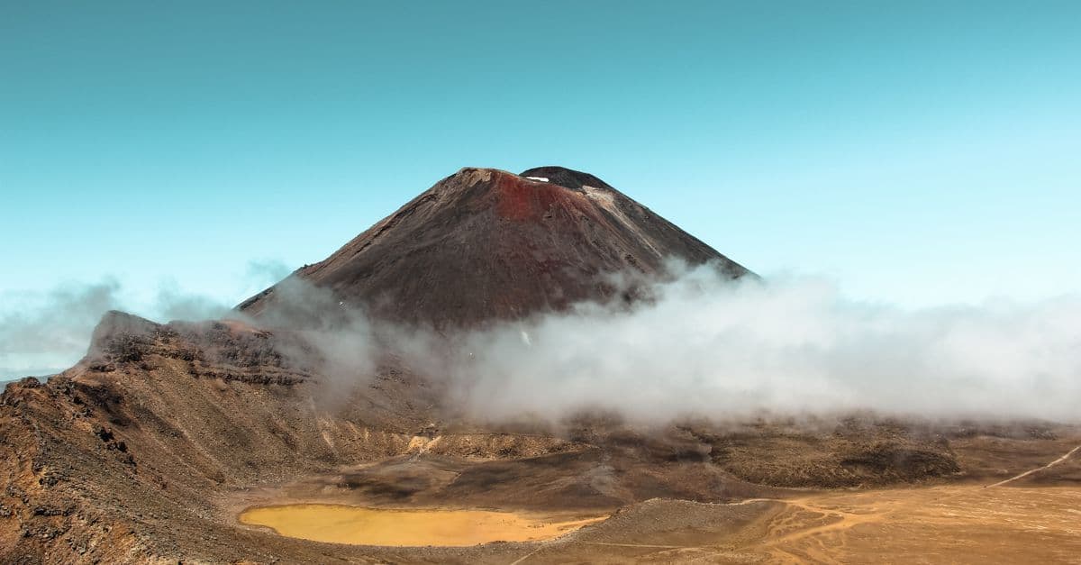 Cloud drifts around the cone of Mount Ngauruhoe, an active volcano in Tongariro National Park, New Zealand.