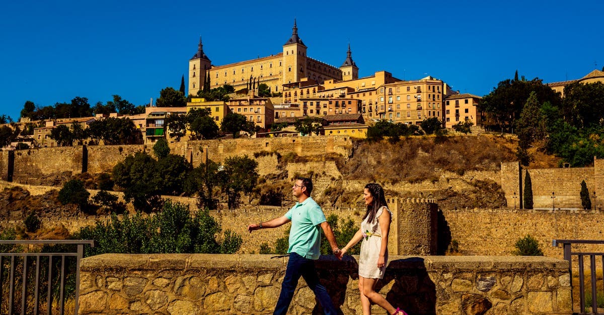 Couple walking near the historic Alcazar of Toledo staying connected with a travel eSIM in Spain