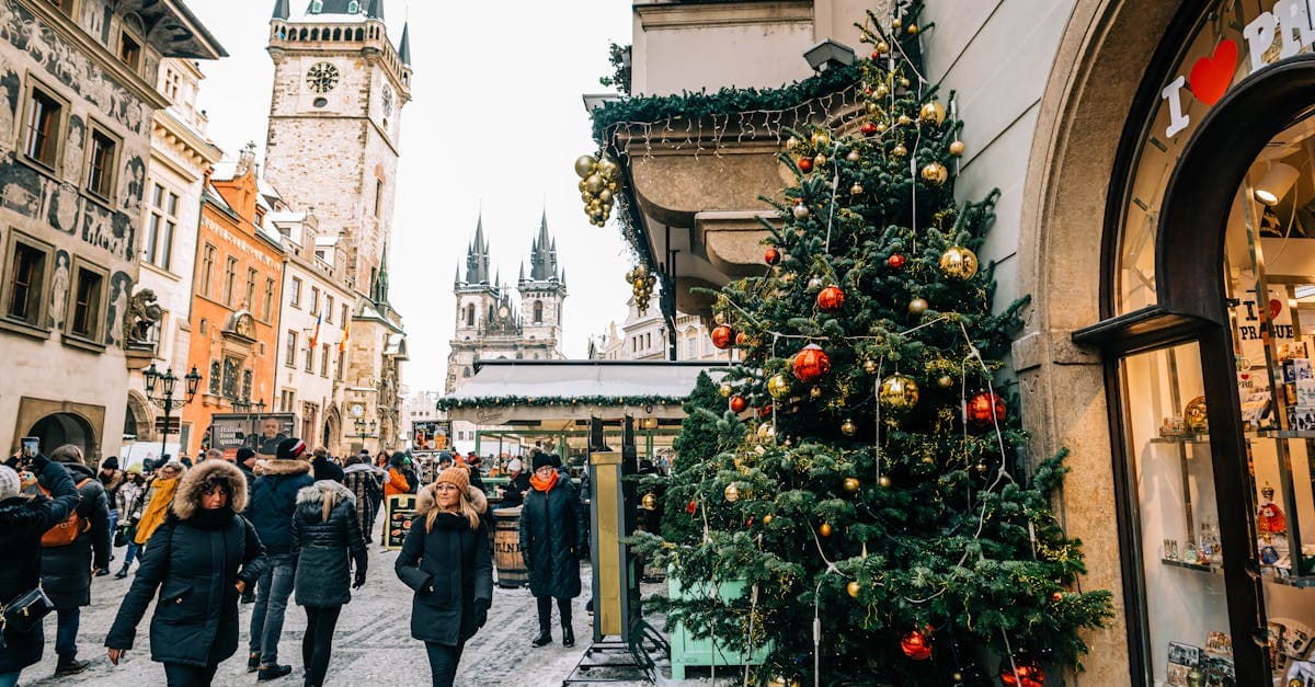 Historic Prague Old Town Square transformed into a vibrant Christmas market with traditional festive decorations.