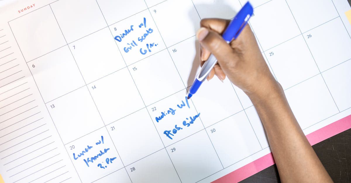 Person marking travel dates on a calendar to plan the cheapest Perth to Bali flights