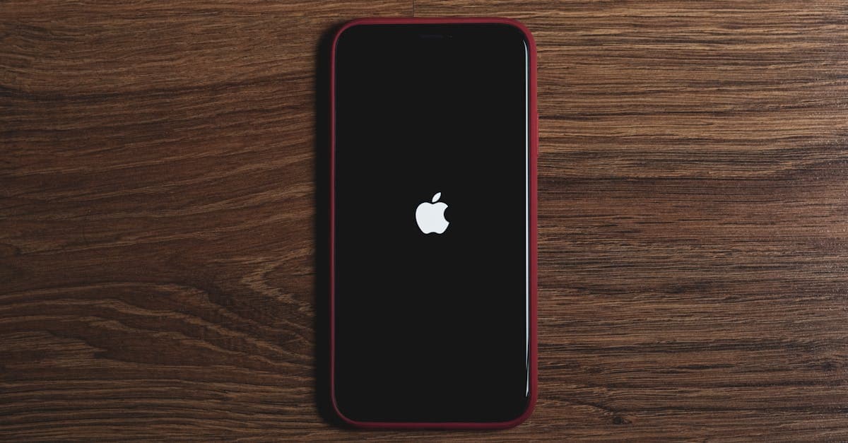 iPhone with Apple logo on wooden surface showing last-resort steps to completely reset Siri