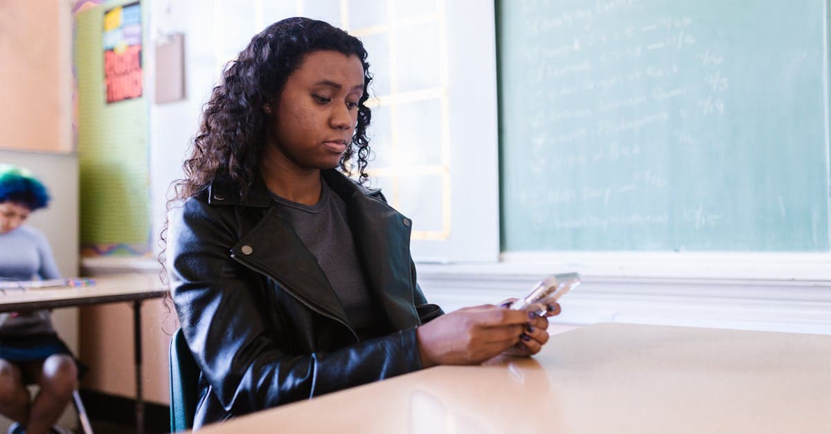 International student at International Hall browsing a smartphone to find a UK mobile data plan.