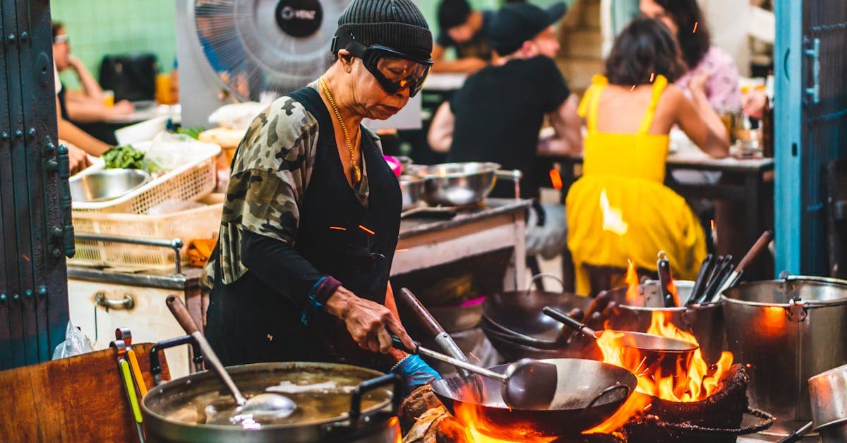 Experienced chef cooking over open flames at a lively street food Vietnam night market