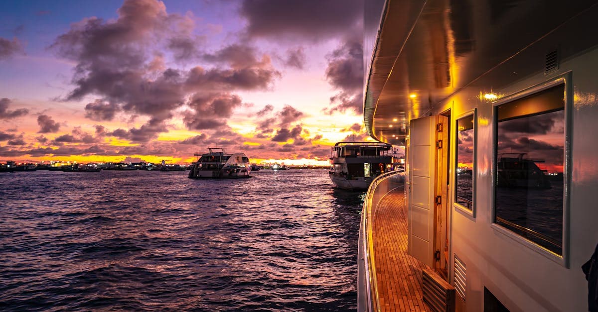 Luxury yachts sailing on calm Maldivian waters at golden sunset, showcasing the best time to visit Maldives