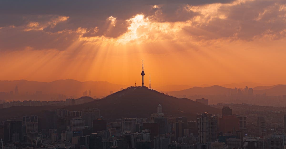Namsan Tower and Seoul skyline bathed in golden sunset light on a Singaporean traveller's itinerary