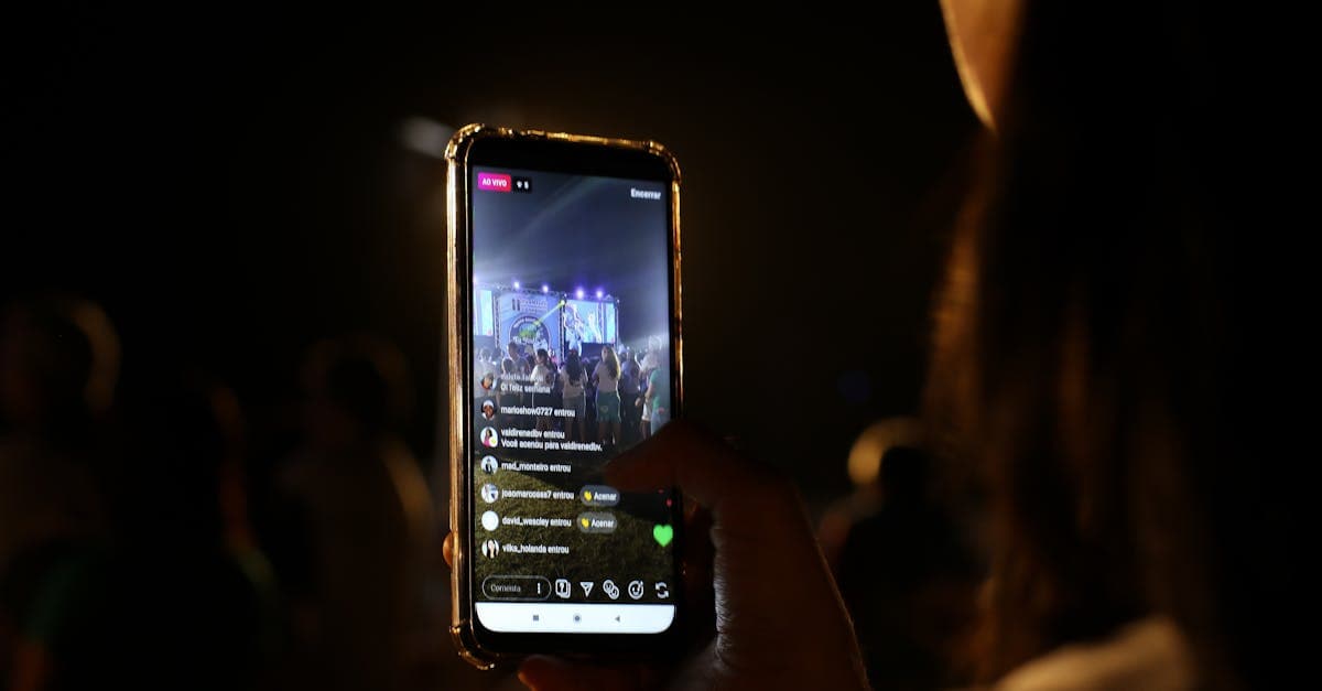 Woman live streaming a concert on her smartphone at night, reflecting streameast app's live stream features.![image