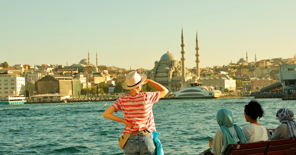 Tourist at Istanbul's waterfront with Suleymaniye Mosque — answering is it safe to travel to Turkey right now