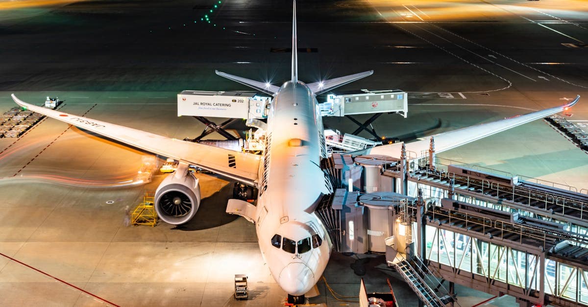 Aerial view of passengers boarding an Airbus at night at Tokyo's busy international airport.
