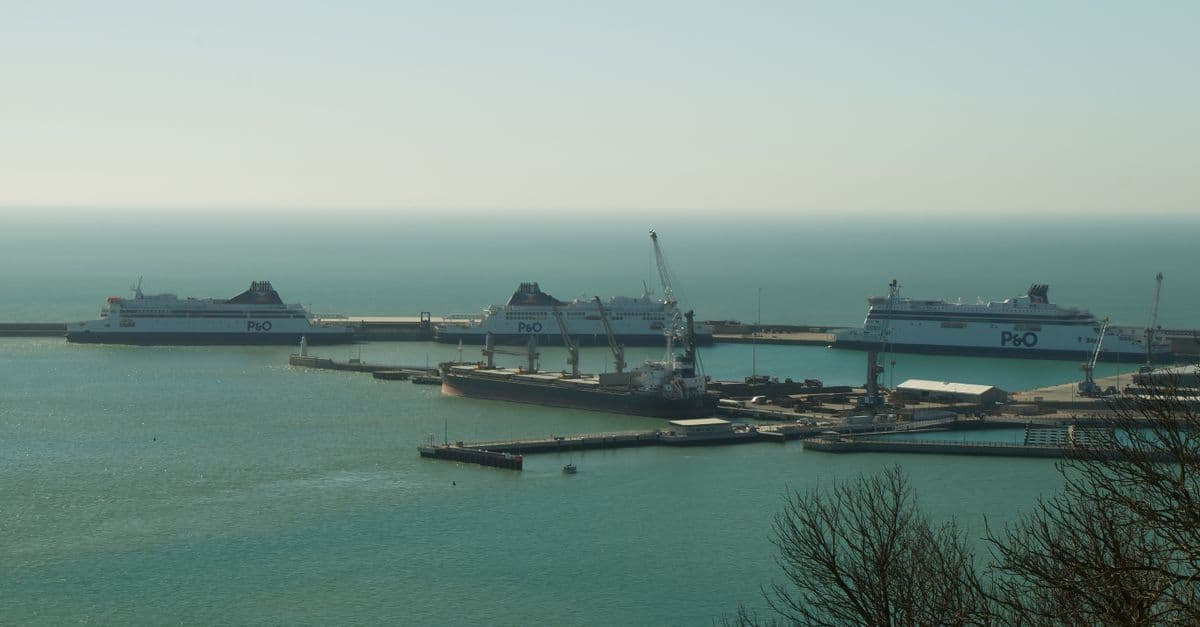 Ferries docked at a busy UK port, illustrating how P&O operates at the ocean cruise terminal berth 46 Southampton.