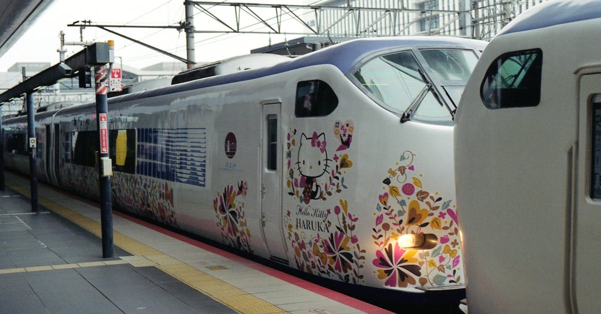 Colorful Hello Kitty themed train at a Kyoto railway station, a fun Japan travel experience