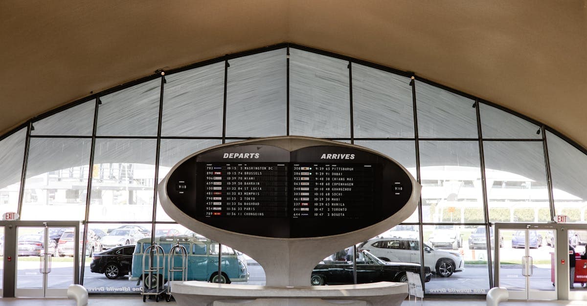 Stylish departure board at JFK's historic TWA terminal where travelers research the best eSIM for international travel