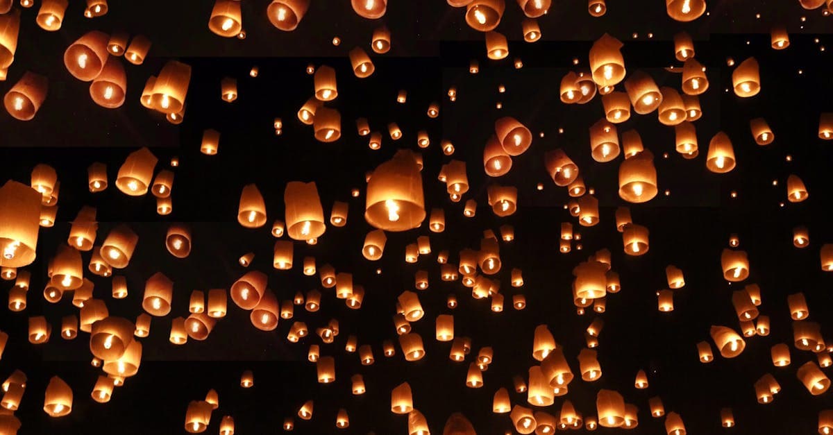 Hundreds of glowing sky lanterns released into the night sky during Chiang Mai's enchanting Yi Peng festival