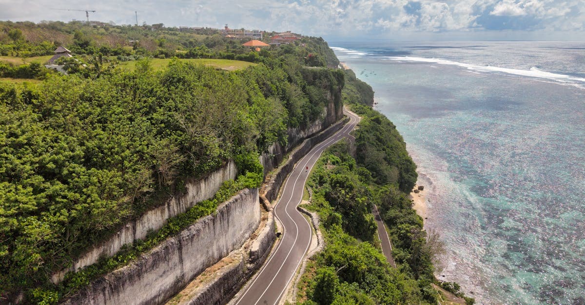 Aerial coastal road winding along Bali's clifftops — context for is Bali safe NZ SafeTravel guidance