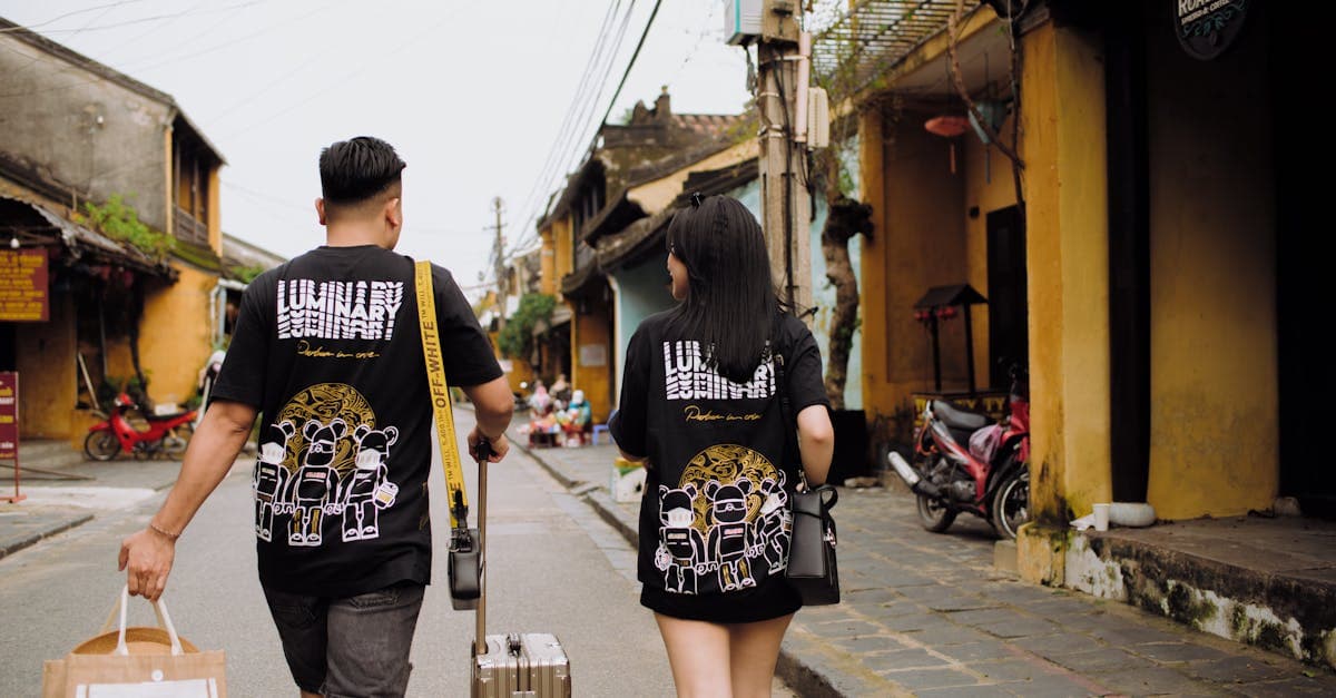 Australian couple with luggage walking through Vietnam's streets, staying connected with a travel eSIM