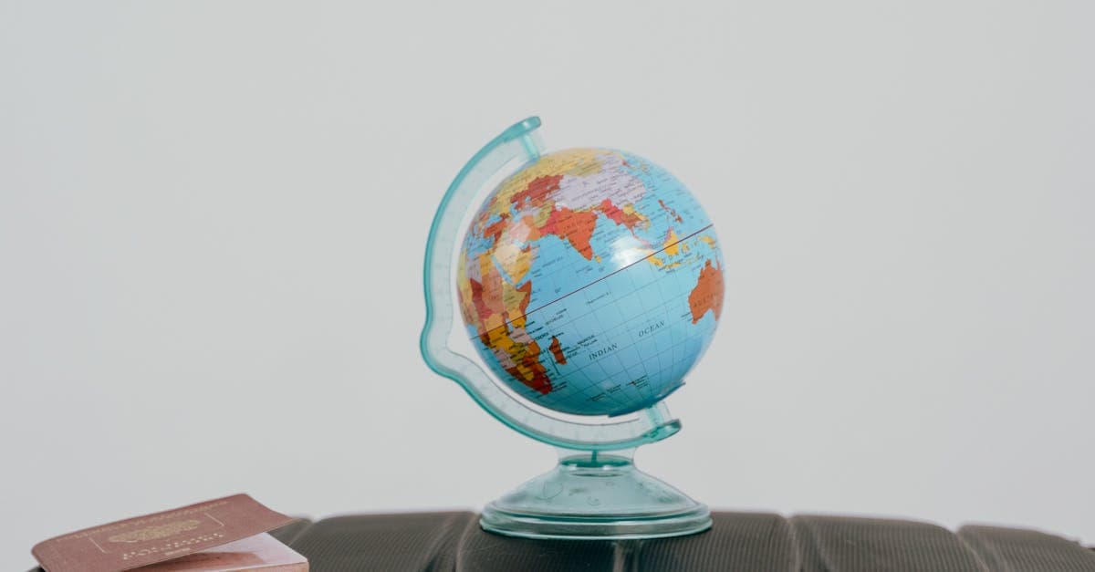 Globe and passport resting on a packed suitcase, representing seamless international roaming with a travel eSIM.