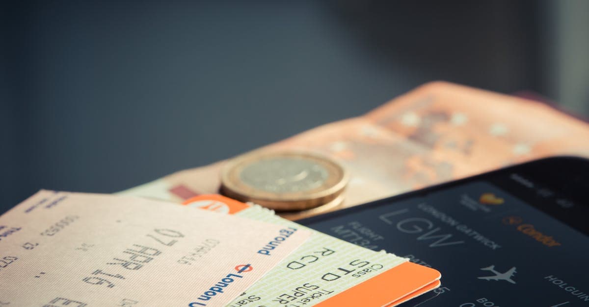 Flugticket mit Euromünzen und Smartphone mit Flugdetails – Preisbenachrichtigungen bei Google Flights einrichten