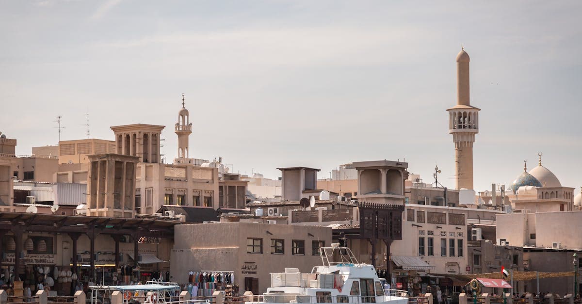 Traditional abras crossing Dubai Creek beside Al Fahidi's historic architecture and bustling old souk district