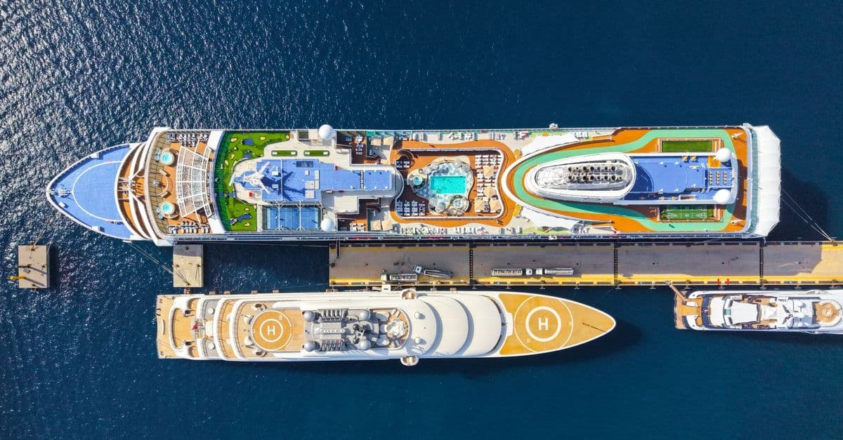Two luxury cruise ships moored at a sunny port, helping travellers identify their correct Southampton terminal.