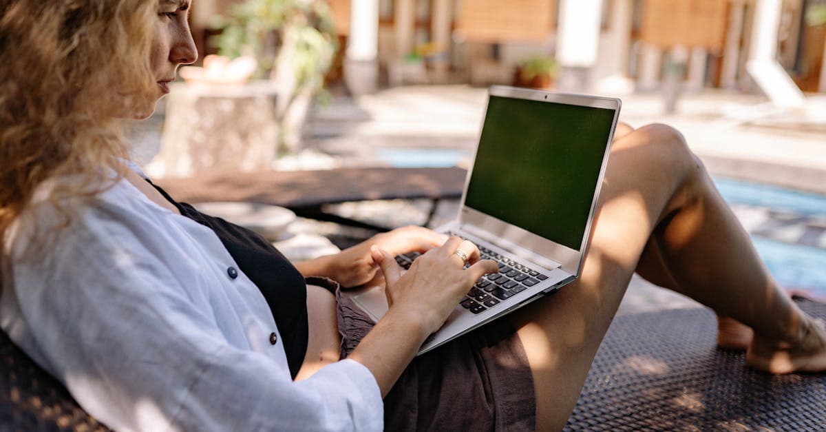 Woman relaxing with laptop poolside in Bali, balancing work and lifestyle as a digital travel eSIM