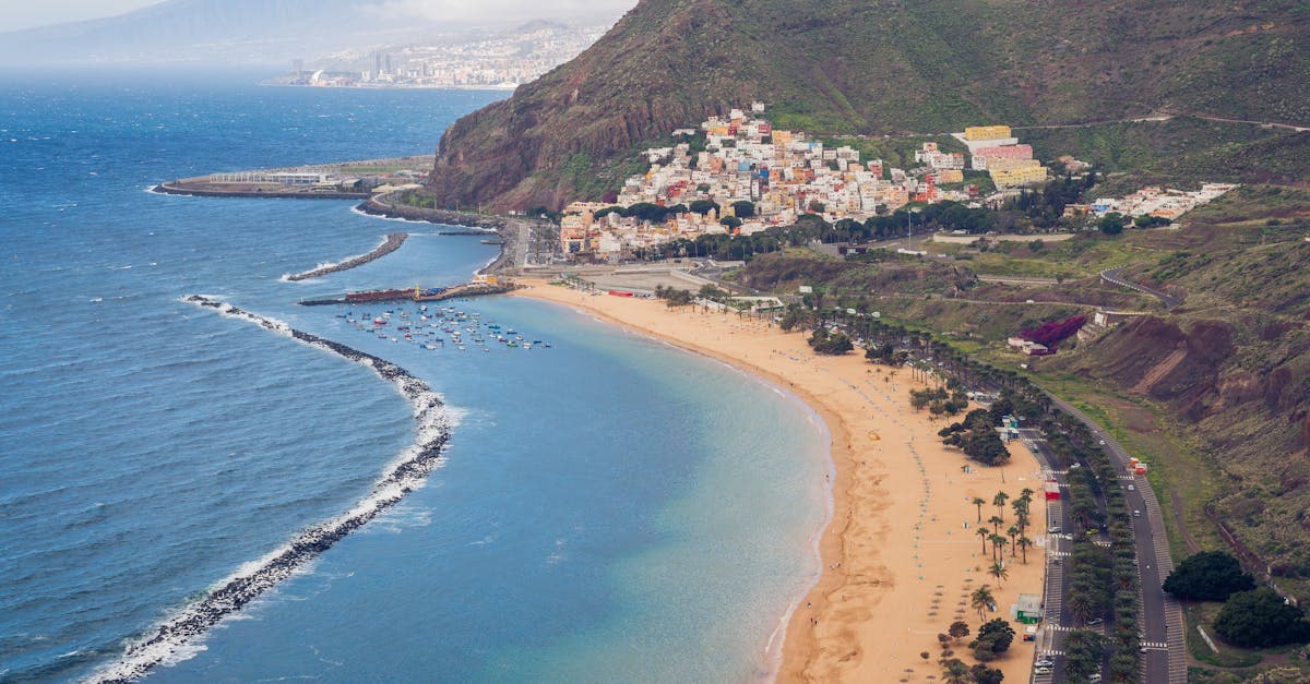 Las Teresitas Beach with golden sand and coastal hills, illustrating Tenerife's warm weather throughout the year