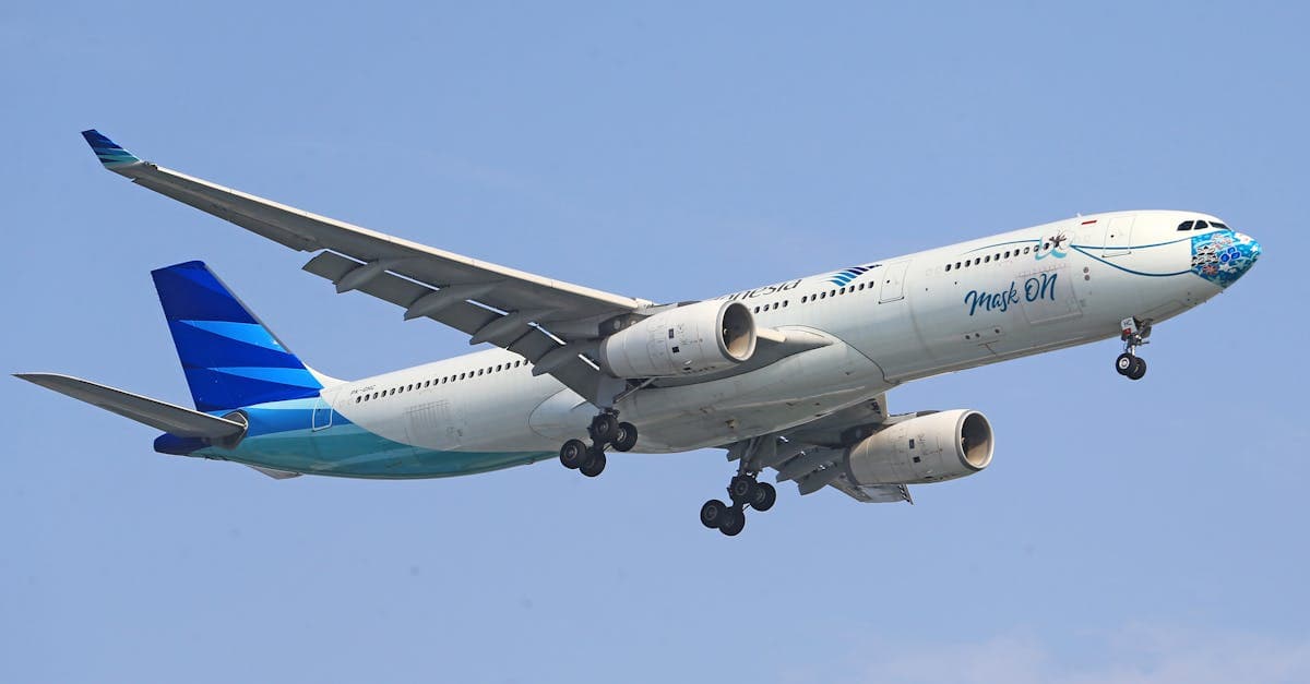 Garuda Indonesia aircraft in flight against a clear blue sky, covering the Perth to Bali route