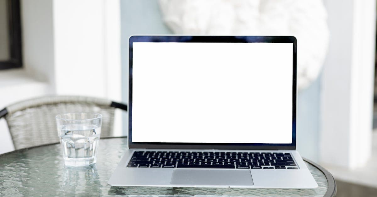 Blank laptop screen on glass table next to water glass showing portable wifi versus eSIM options
