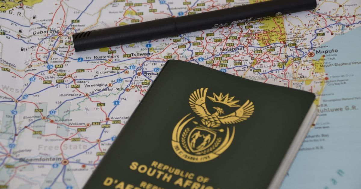Passaporte sobre mapa-múndi detalhado representando as possibilidades do working holiday visa para viajantes