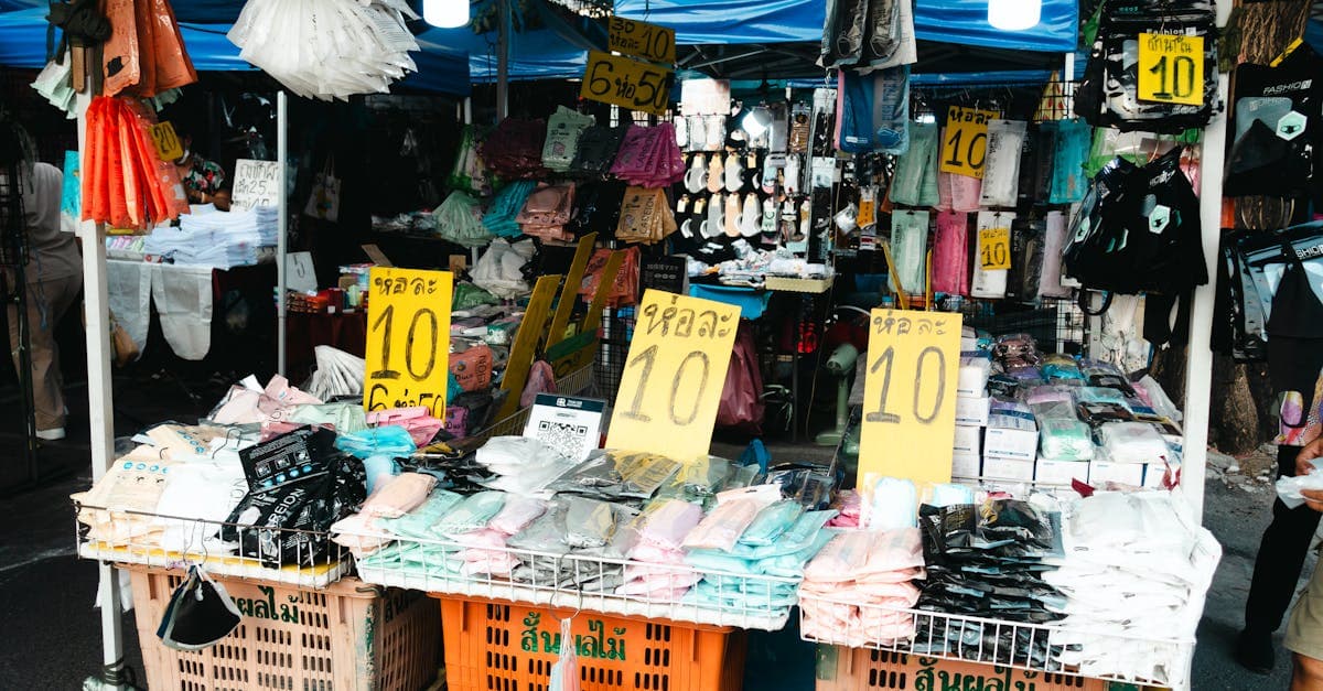 Colourful street market with clothing stalls and sale signs, ideal for budget city break shopping