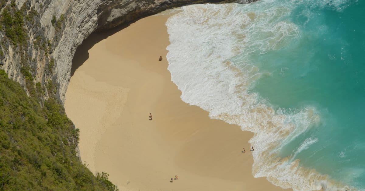 Aerial view of a secluded Bali beach with turquoise waters, a destination Australians need a Bali visa to visit.