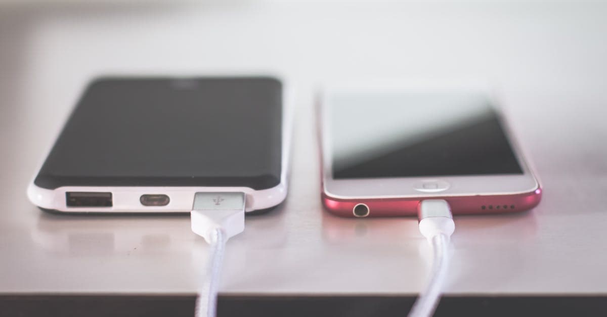 Two smartphones charging side by side comparing phone tethering against a dedicated portable wifi hotspot