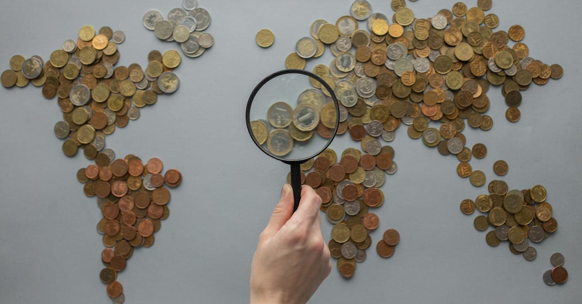 Creative world map composed of coins with magnifying glass highlighting Europe's cheapest countries to visit.