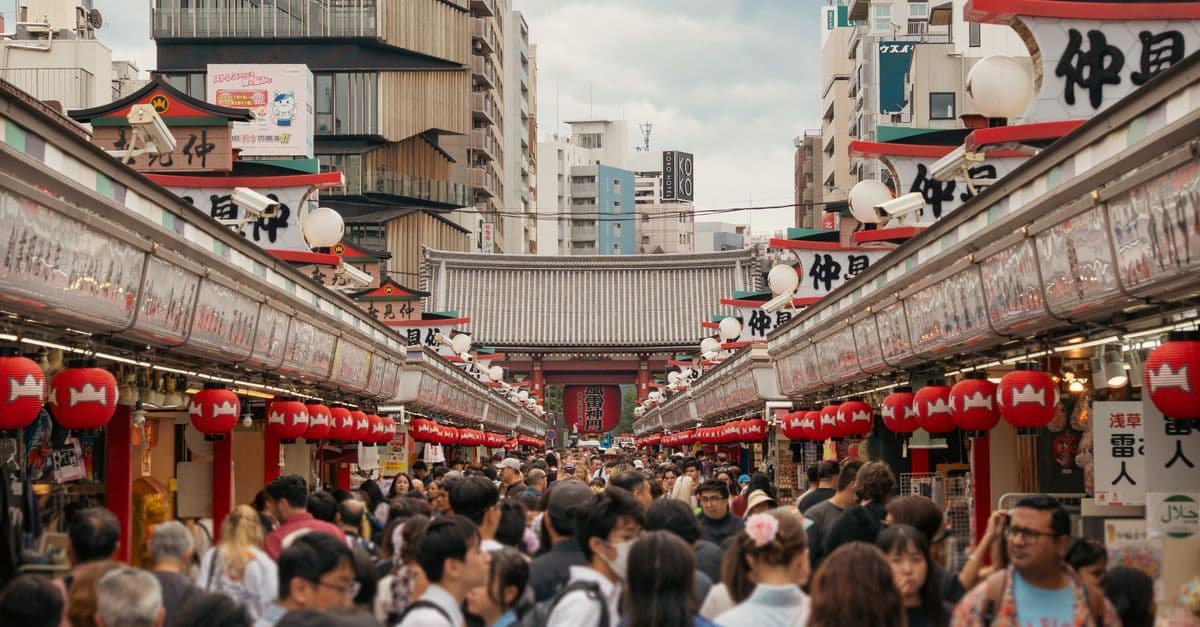 Crowds exploring Nakamise shopping street, one of the most authentic things to do in Tokyo.