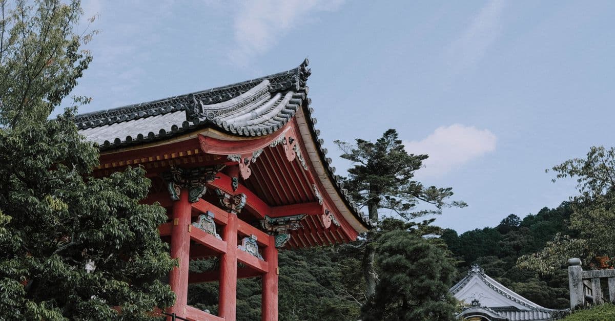 Kyoto pagoda nestled among lush trees, capturing the best time to visit Japan in autumn.