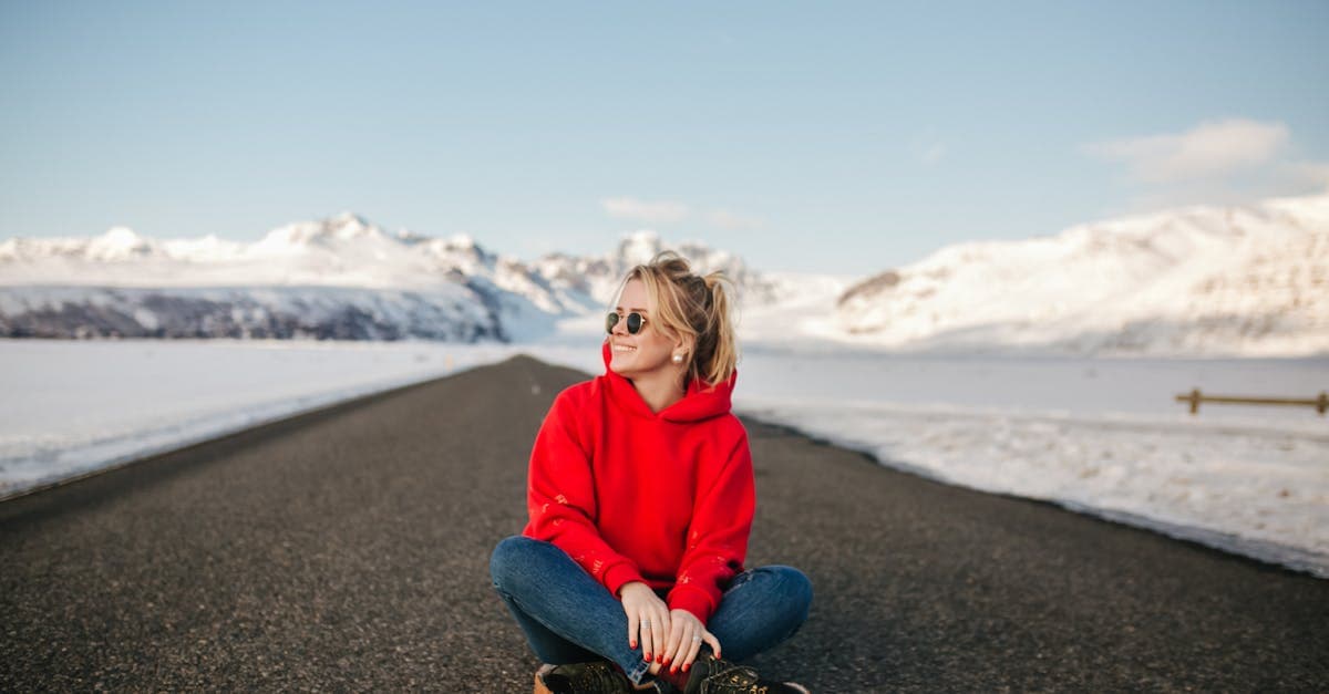 South African woman on a snowy mountain road, preparing for a solo trip to Europe