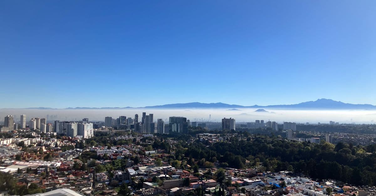 Aerial view of Mexico City during daytime showing clear skies and the mild mexico city weather