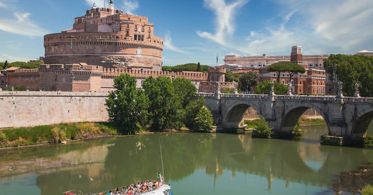 Castel Sant'Angelo and the Tiber River at dusk with a tour boat, proving food tour rome delivers unforgettable value