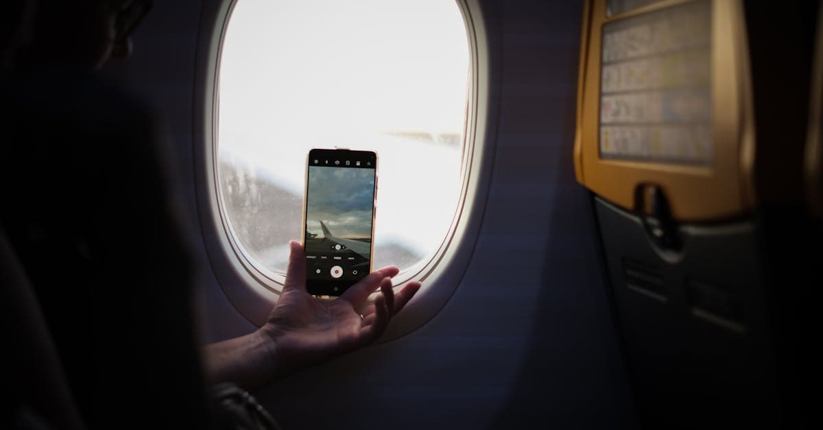 Airplane window view during a daytime flight, perfect for playing Gartic Phone game modes mid-trip