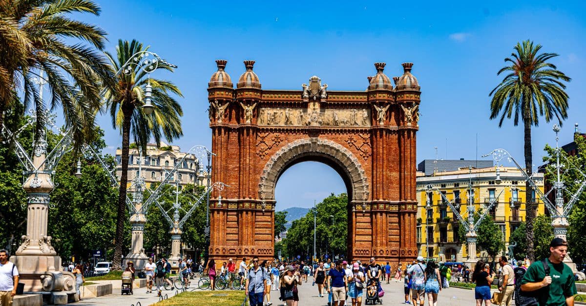 Crowds of visitors enjoying the Arc de Triomf promenade, a highlight of any Barcelona holiday